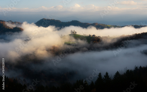 Cloud inversion at Saint Thomas Church in Slovenia during sunrise in autumn