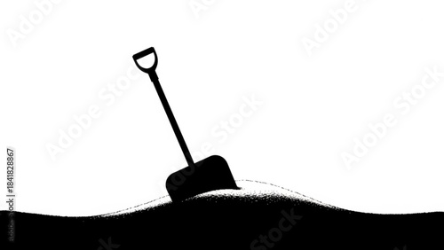 Black silhouette of a shovel stuck in the ground on