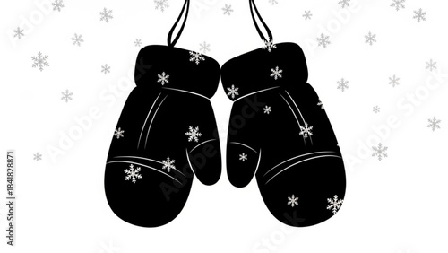 Black mittens with white snowflakes hanging on a string isolated on