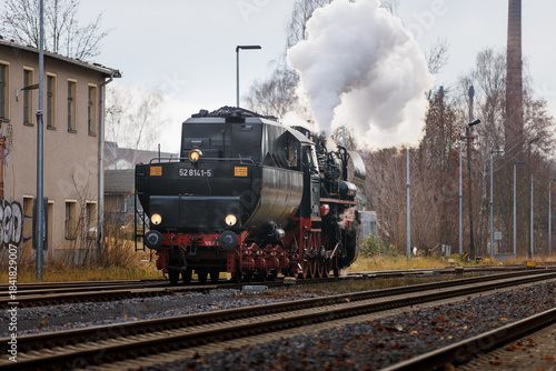 old steam train Dampflok with a lot of steam in saxony bischofswerda 528141-5 Dampflok