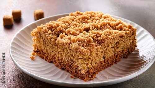 golden crumble coffee cake on a white plate