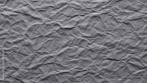 Detailed close-up of a crumpled and wrinkled gray paper texture background