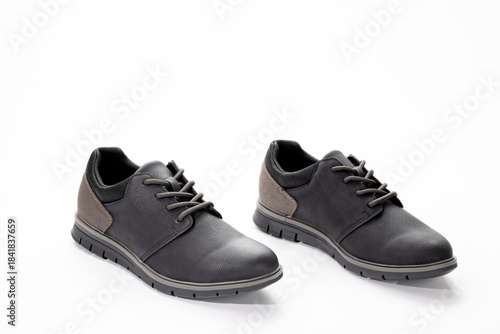 Pair of black and gray casual men’s shoes photographed in studio on a white background, showing modern footwear design, materials, and style for fashion or retail use.