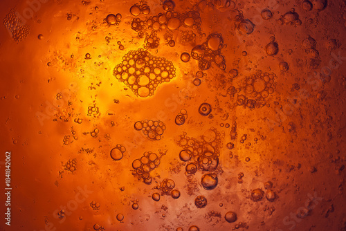 Frozen bubbles in ice. Ice texture. Dark orange grunge abstract