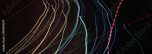 Abstract neon light trails. Long exposure. Dark motion blur background with copy space.