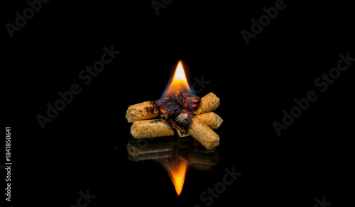 Quadro em tela Burning Wood Pellets Arranged Like Star, Isolated On Black Background With Small