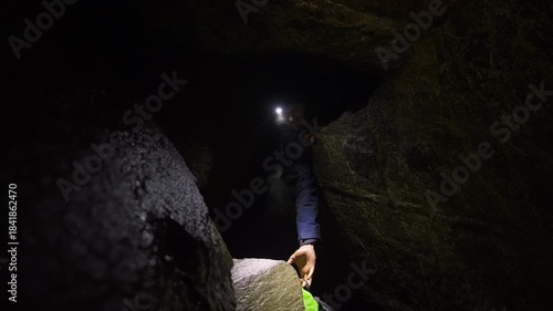 Backpack Lowered Through Narrow Cave Passage