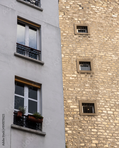Contrasting Building Facades with Windows on Stone and Plaster Walls