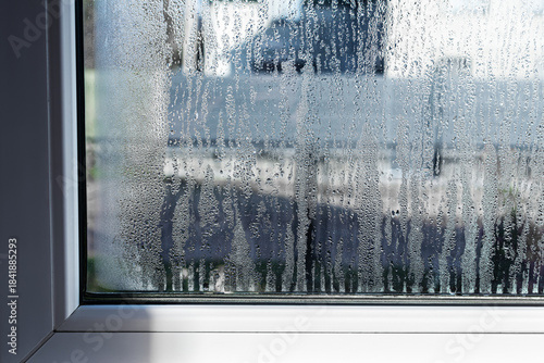 Drops of condensation on the metal-plastic window. Fragment of a plastic window with water condensation on the glass, temperature difference, humidity in the room, humidity problem. 