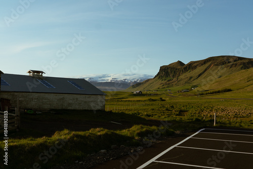 Icelandic Countryside with Mountain View and Farm Buildings at Sunset