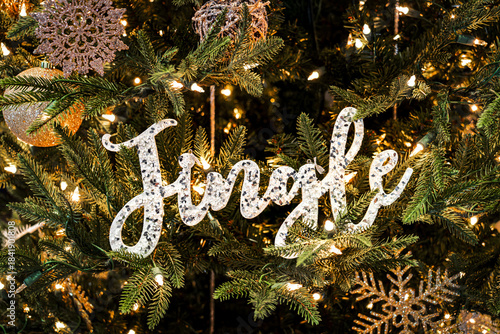 sparkly Jingle ornament on a Holiday tree with white lights and gold ornaments