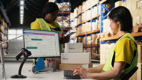 Bild auf Leinwand Team of workers fulfilling warehouse supply and demand operations for package tracking and order processing, checking shipment details on pc monitor