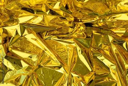 high-resolution close-up shot of crumpled golden foil