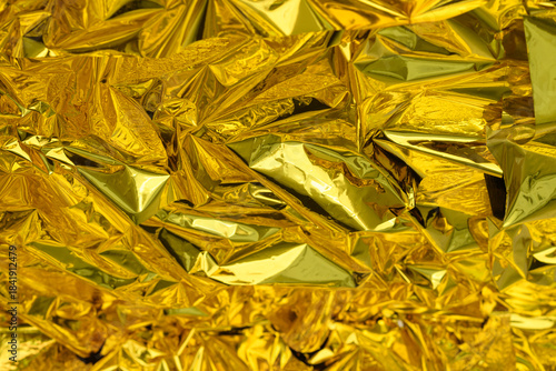 high-resolution close-up shot of crumpled golden foil.Selective focus.