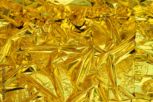 high-resolution close-up shot of crumpled golden foil
