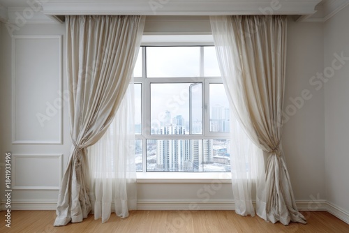 Elegant beige curtains frame a large window with city views.