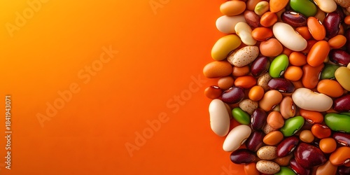 Colorful beans on orange surface