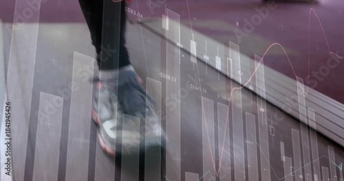 Right foot making contact, gray shoes rolling on treadmill while market graphs tracking performance
