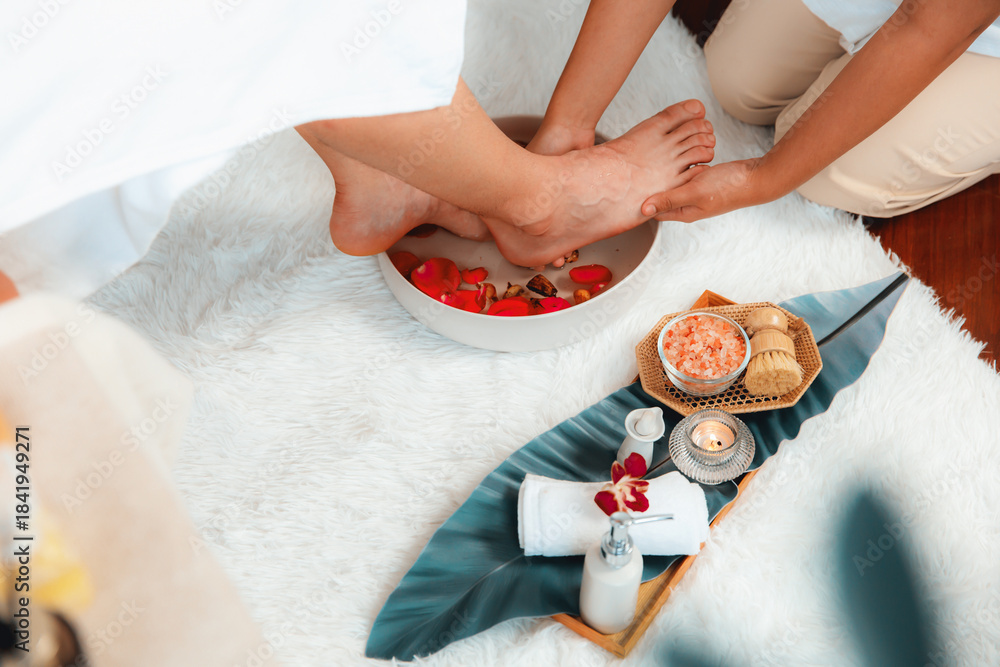 Naklejka premium Man indulges in blissful foot massage at luxurious spa salon while masseur give reflexology therapy in gentle day light ambiance resort or hotel foot spa. Quiescent