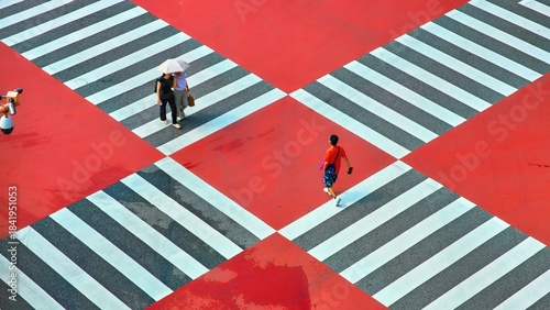 Pedestrians Crossing a Vibrant Red and White Urban Crosswalk