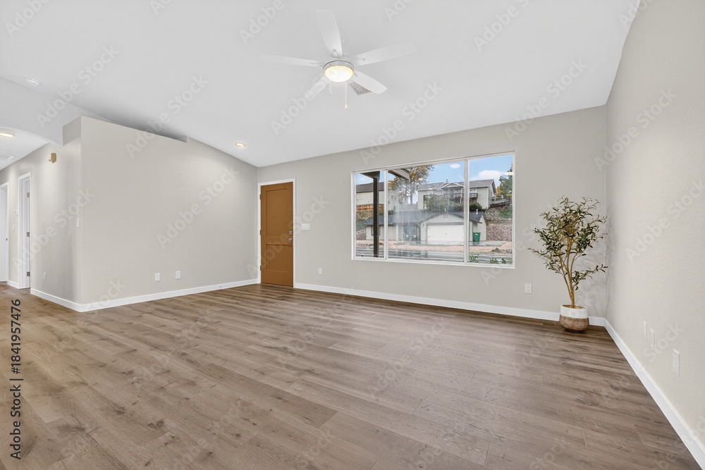 Fototapeta premium Open Bright Living Space, Welllit Open Living Room With Vaulted Ceiling And Natural Sunlight