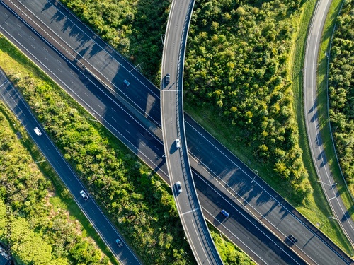 Aerial view of cars driving on a highway interchange in Manukau, Auckland, New Zealand. The photo shows the infrastructure and transportation system.