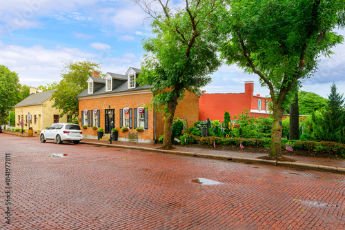 Fototapeta Naklejka Na Ścianę i Meble -  Autumn view after a rain storm of the brick paved Main Street in the historic small town of St. Charles, Missouri.