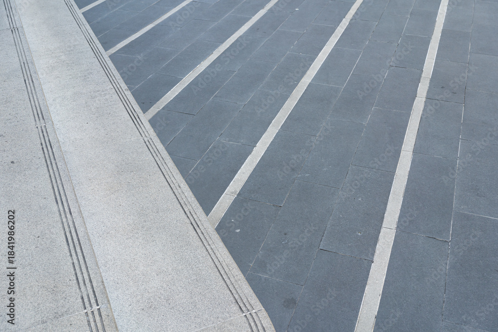 Fototapeta premium Modern Granite Staircase and Tiled Ground Texture. architecture, urban design, modernity, and safety.