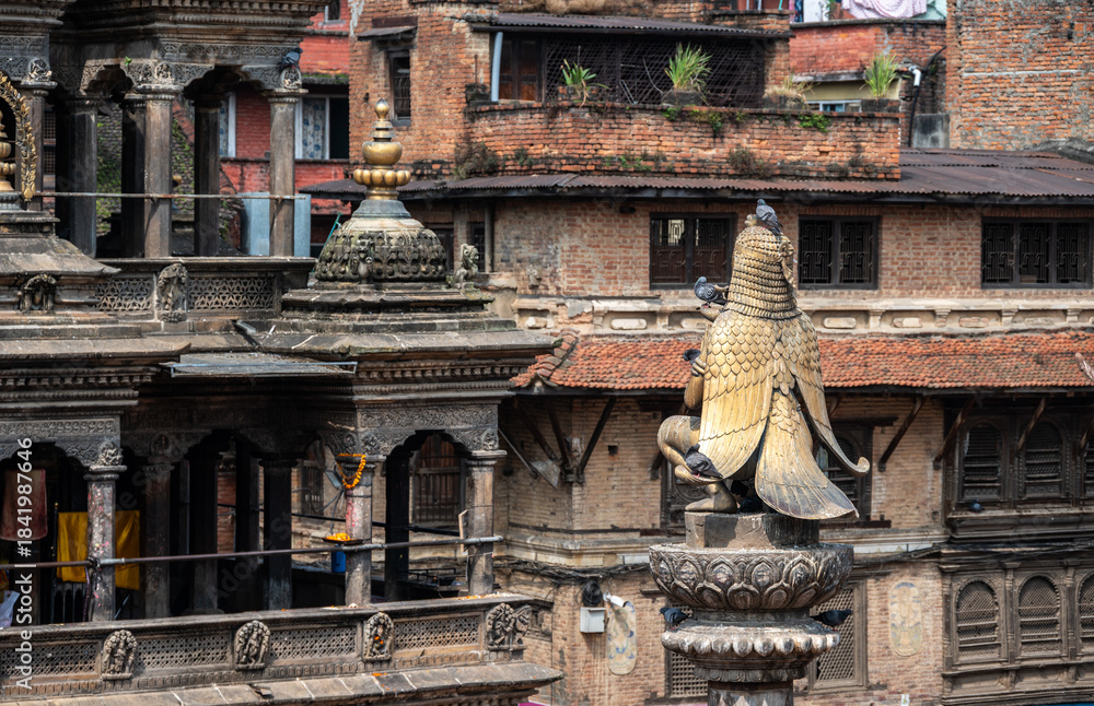 Fototapeta premium Rear view of the Garuda statue sitting on stone pillar in Patan Durbar Square, Nepal. Patan Durbar Square is one of three Durbar Squares in Kathmandu, Nepal.