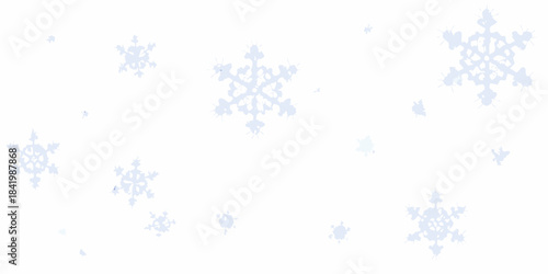 Delicate snowflakes gently falling against a clean bright white background