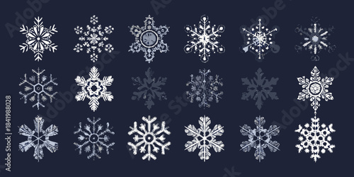 An assortment of intricate white snowflakes on a dark blue background