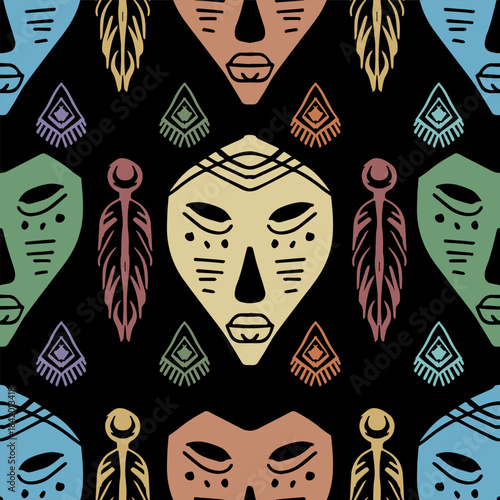 Ethnic seamless pattern with tribal mask and feathers on black background. Vector illustration.