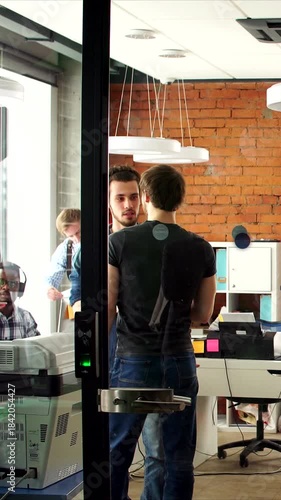 Vertical video, Office environment buzzes with enthusiasm and teamwork, Dynamic team in contemporary workspace enthusiastically reviews project plans amid lively and productive setting