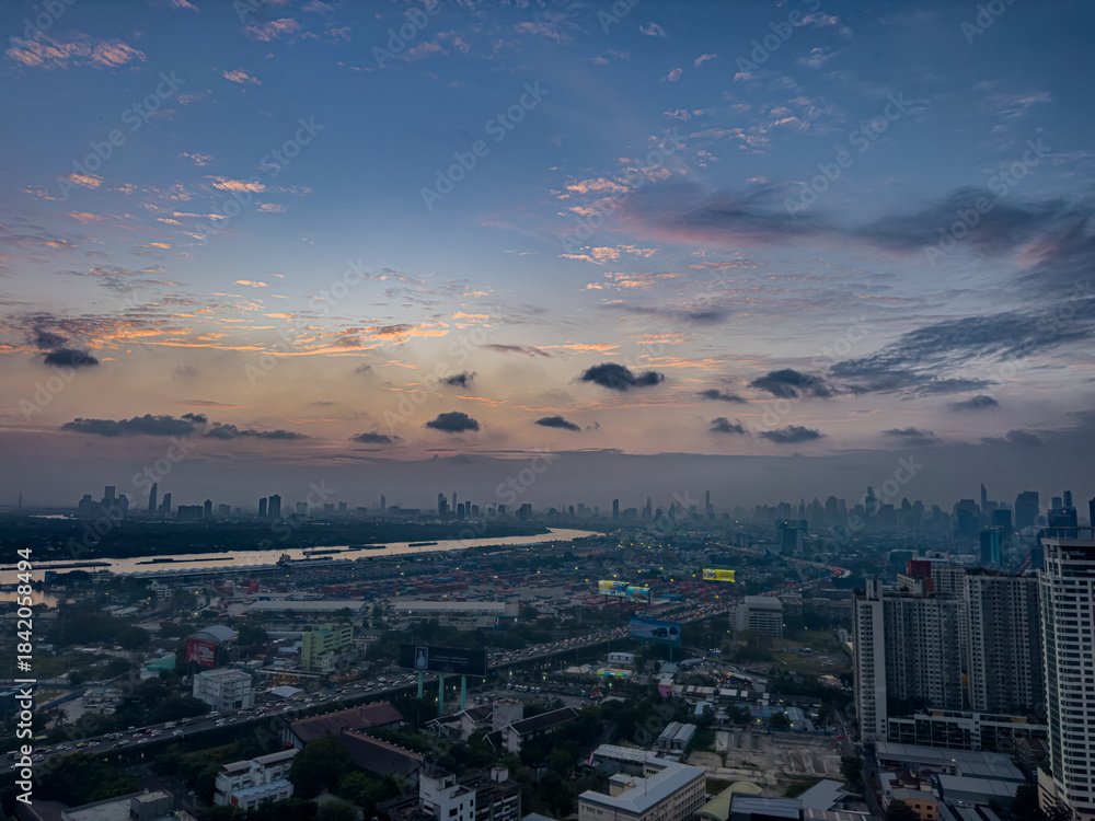 Obraz premium 13 December 2025 colourful sunset with fluffy white pink purple orange and blue skies over the city towers of BKK Bangkok Thai Thailand