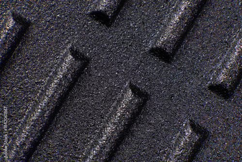 Surface texture of a rcast iron grill pan showing patterns in close detail during daylight hours