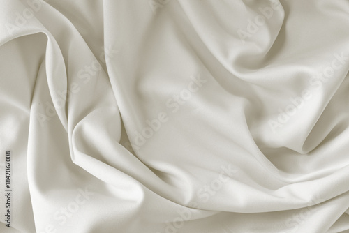 Cloud dancer toned silk fabric background with folds. Copy space. Monochrome background 2026 color.