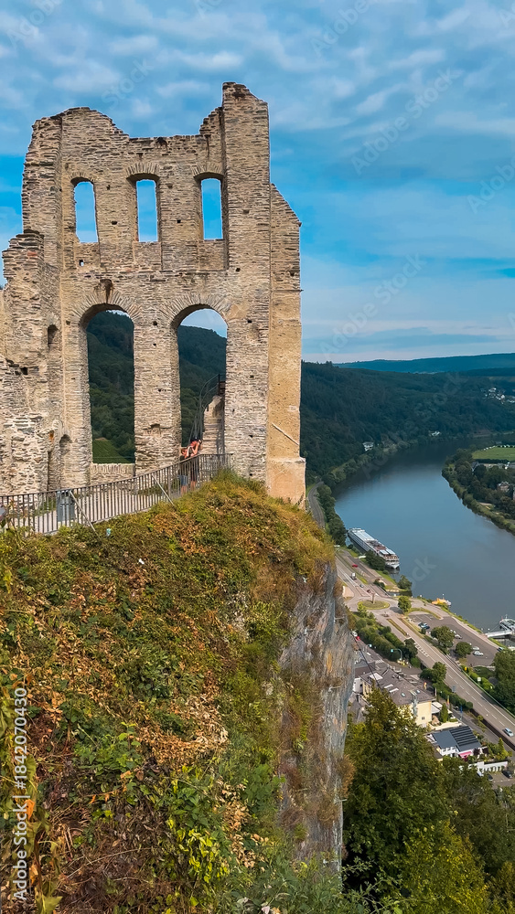 Obraz premium Ancient ruins on a hill opposite the Moselle wine town of Traben-Trarbach, Germany, July 23, 2024.