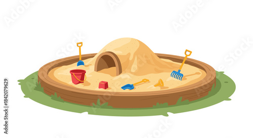 A children's sandbox in a backyard or playground, filled with sand toys like a bucket, shovels, and a rake.