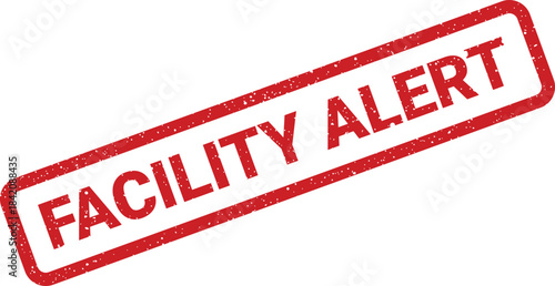 Red distressed rubber stamp with text FACILITY ALERT on a white isolated surface creating a warning message