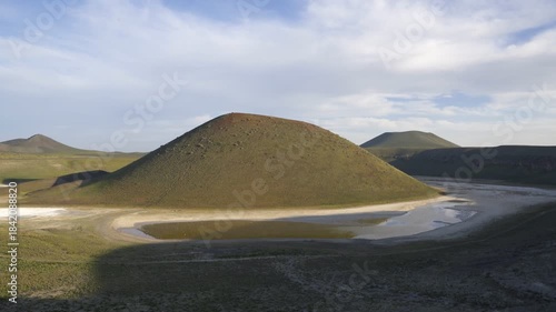 Lake Meke showing its volcanic crater formation with limited water surrounded by hills in Turkey