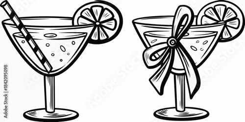 Two elegant cocktail glasses garnished with citrus and decorative elements