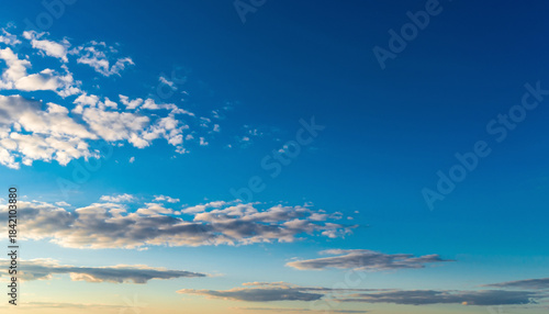 Vivid Blue Sky with Scattered White Cumulus Clouds on a Bright Sunny Day, Atmospheric Landscape Background Showing Clear Weather and Soft Cloud Formations