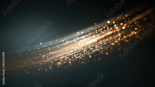 A trail of sparkling light particles sweeping diagonally across a dark gradient background Motion blur conveys movement while