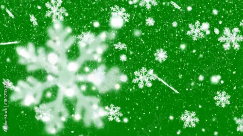 Animated white snowflakes falling on green backdrop seasonal festive abstract