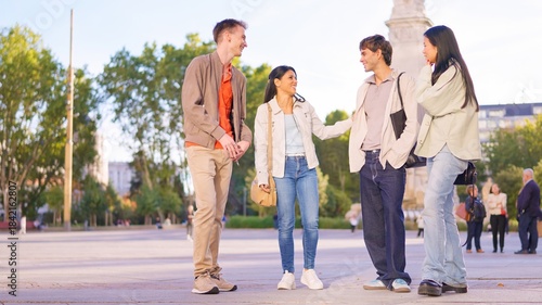Diverse friends group having an inclusive conversation outdoors in city