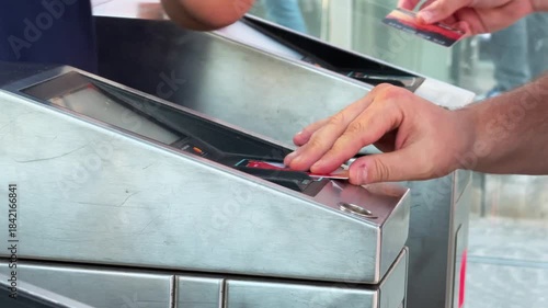 Commuter tapping transport card at turnstile with insufficient balance at tram or metro station