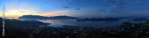 Wide high angle view of Coron Town harbor and islands during golden sunrise on Busuanga Island, Palawan, Philippines
