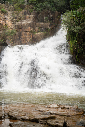 Wallpaper Mural Majestic waterfall cascading over rocky landscape in a serene natural setting. Torontodigital.ca