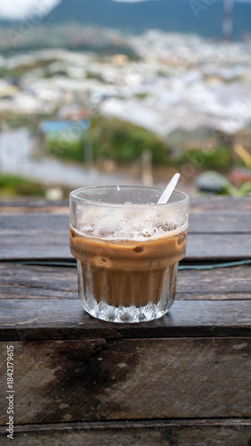 Wallpaper Mural Chilled coffee drink in a glass, set against a blurred outdoor background. Torontodigital.ca