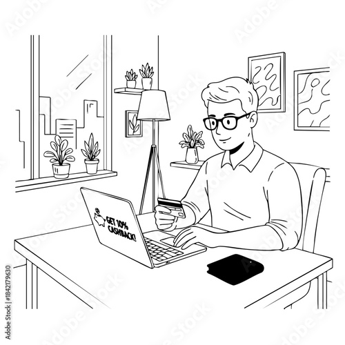 A man is sitting at a desk with a laptop and a credit card. He is typing on the laptop and he is focused on his work. Concept of productivity and concentration